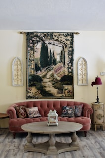 a living room filled with furniture and a painting on the wall
