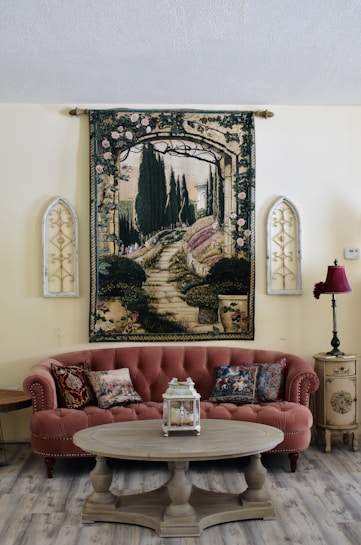 a living room filled with furniture and a painting on the wall