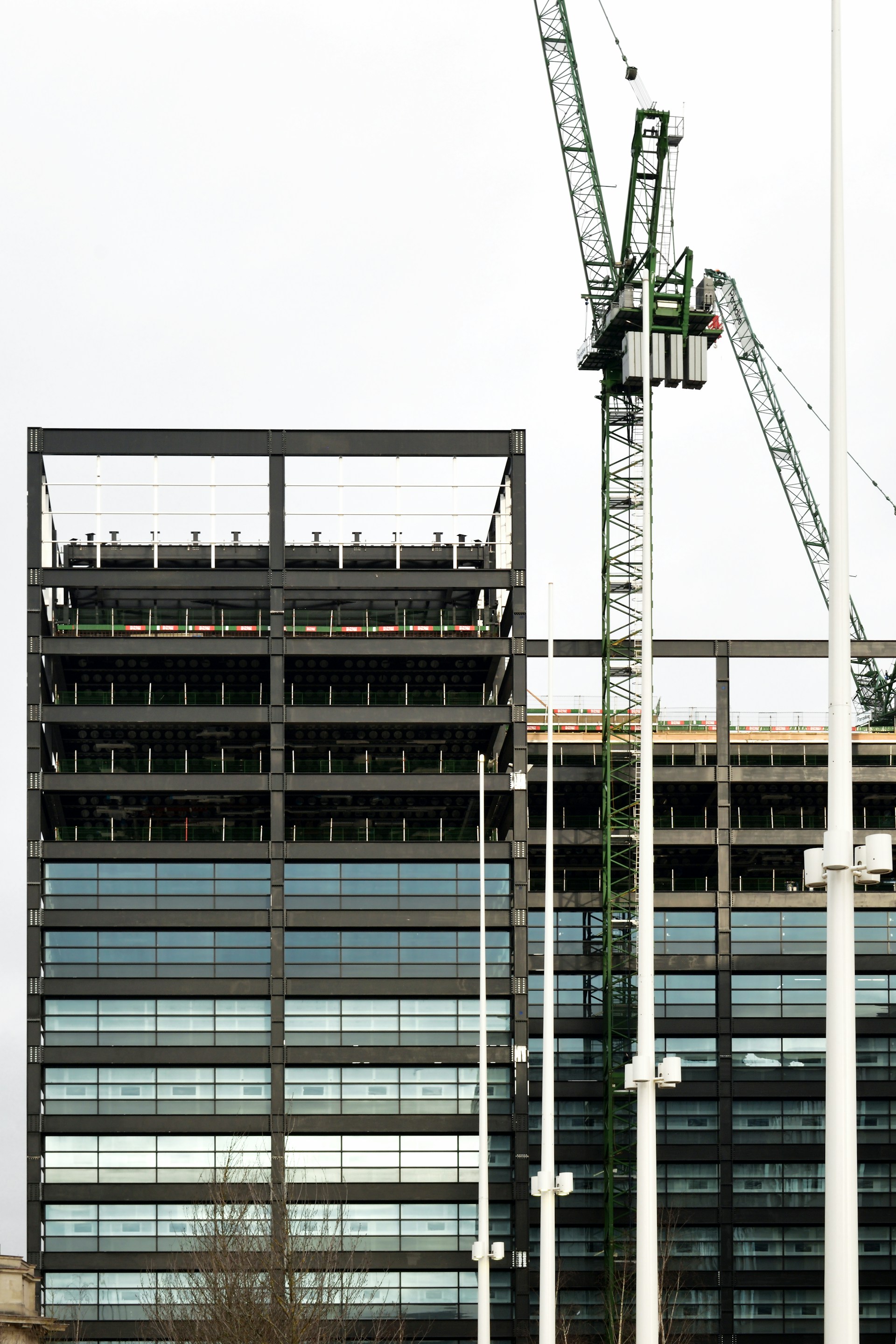 a crane is standing in front of a building