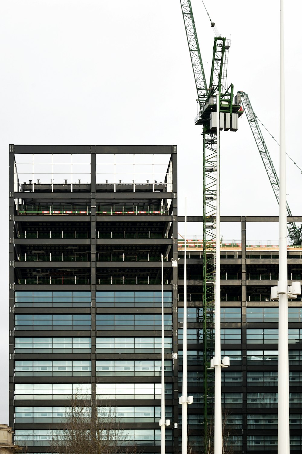 a crane is standing in front of a building