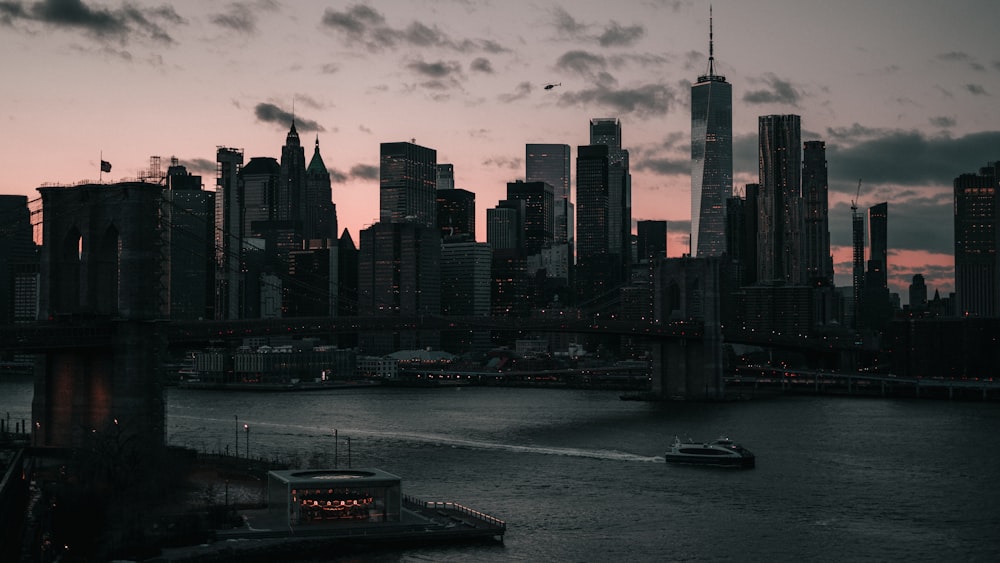 a city skyline with a boat in the water