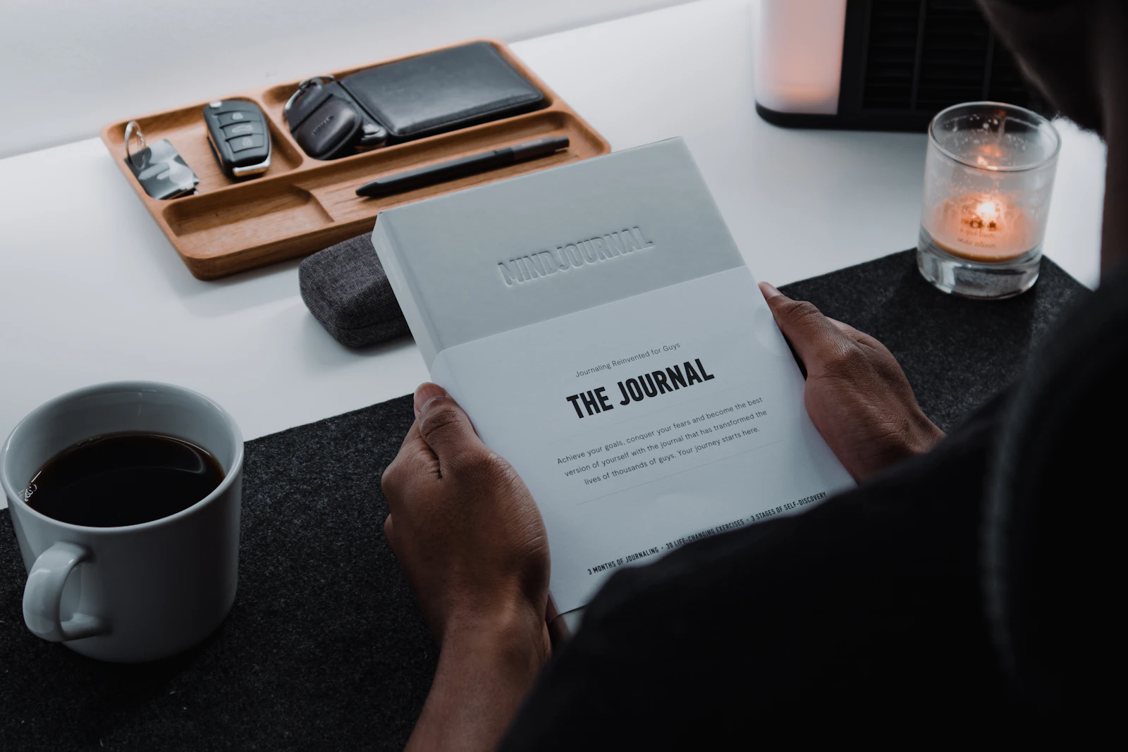 A person using a journal to build a calm, structured daily routine.