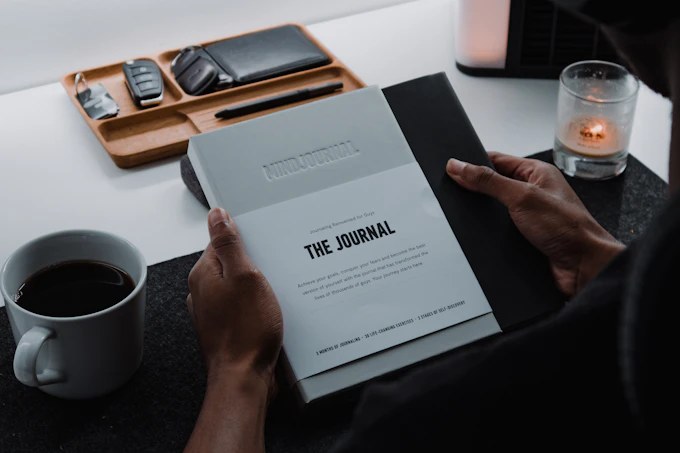 Journaling beside a warm drink in a calm home setting
