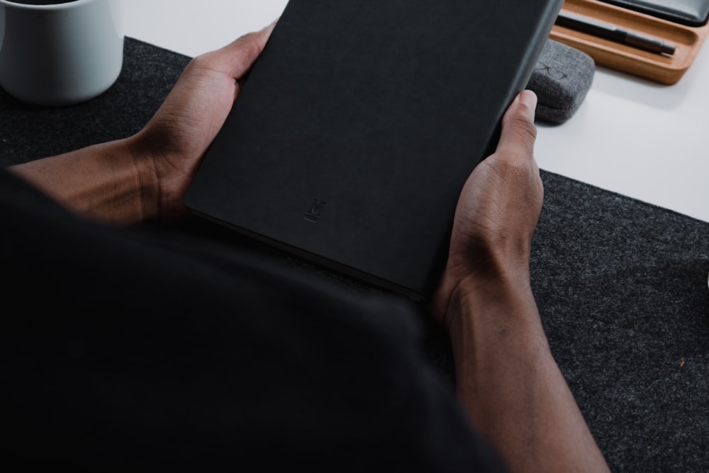 a person holding a tablet in their hands