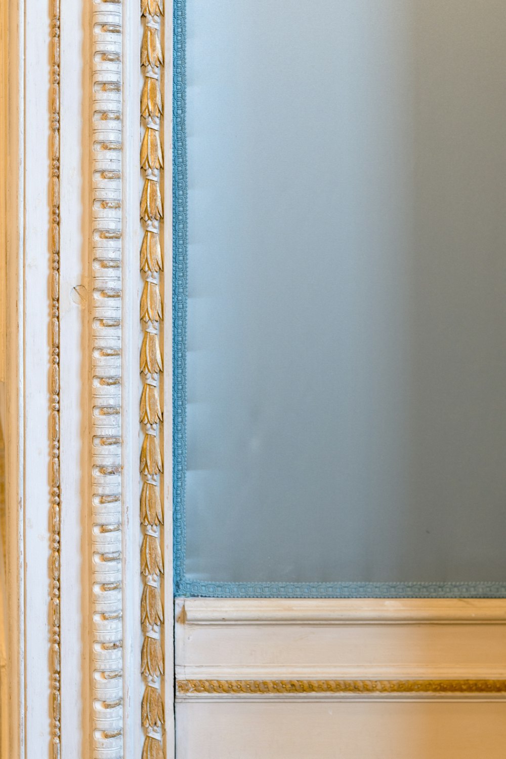 a mirror with a blue frame in a room