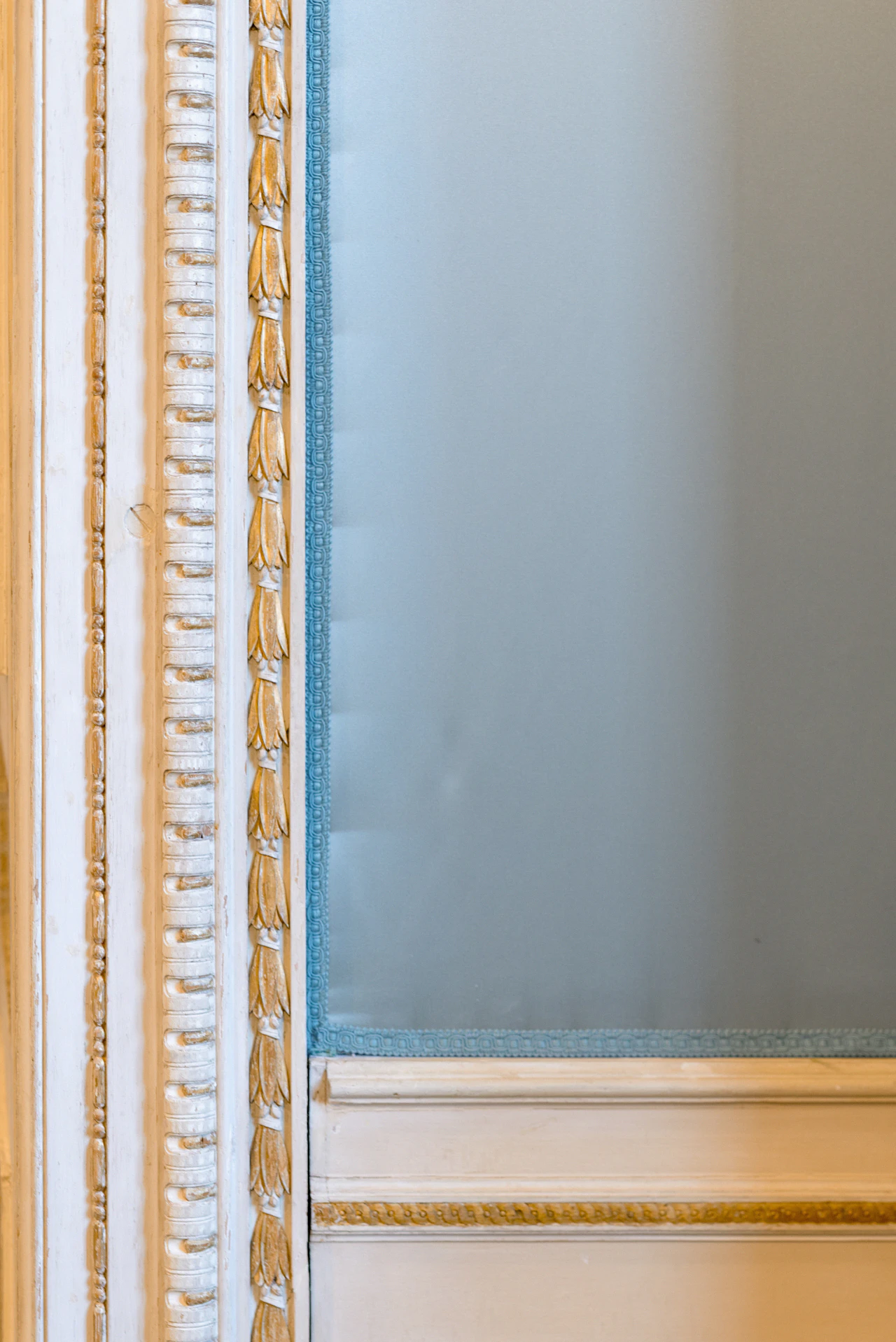 A framed mirror set against restored plaster