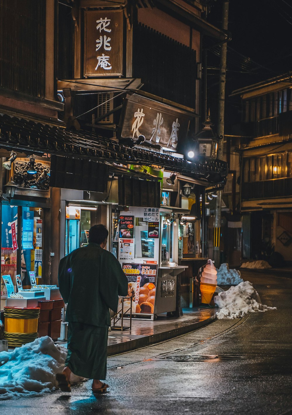 a man walking down a street at night