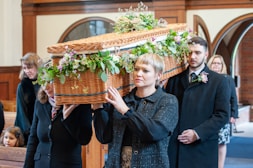 a woman holding a basket with flowers on it