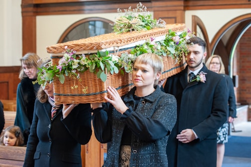 a woman holding a basket with flowers on it