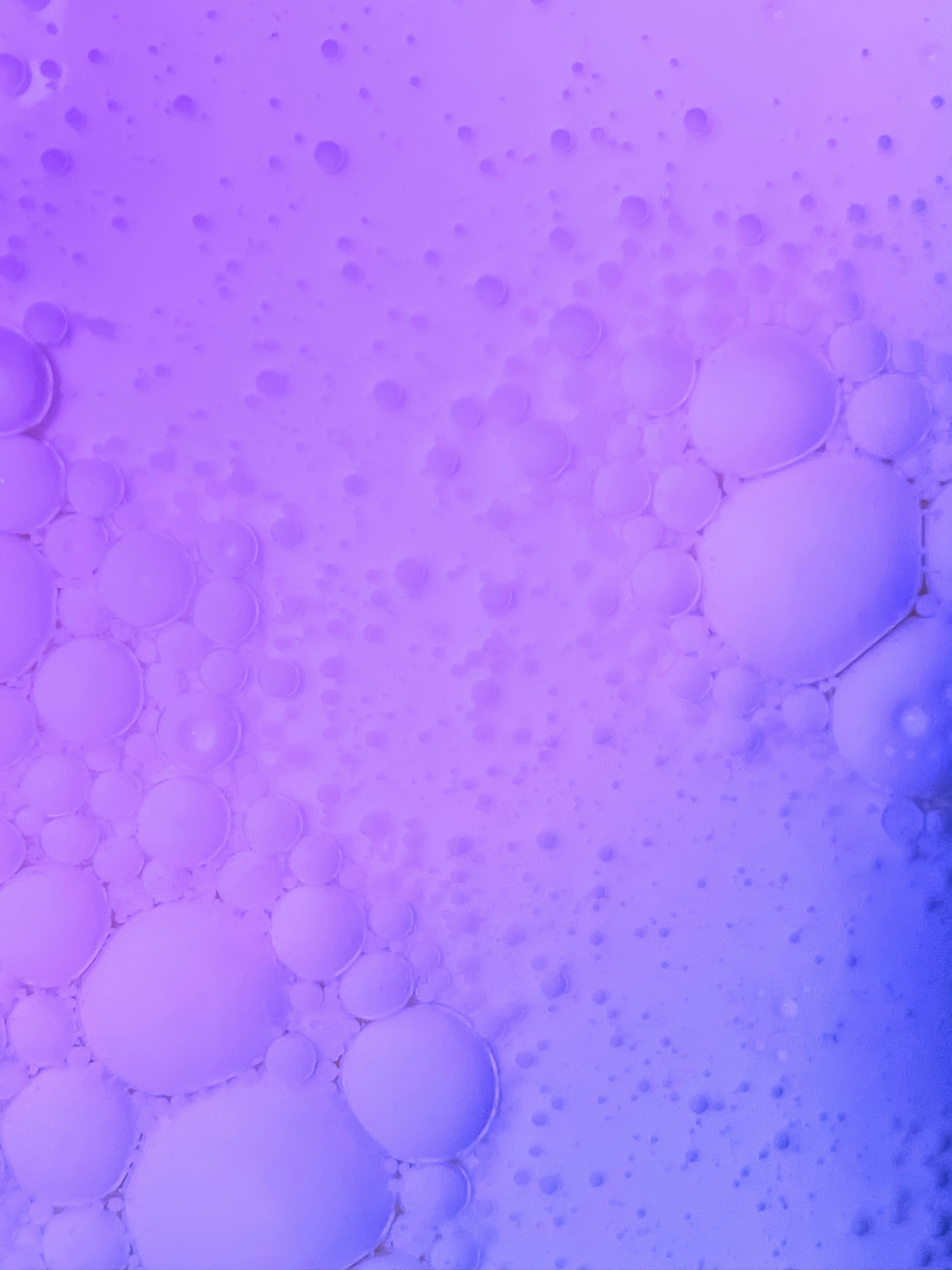 a close up of bubbles in a blue and pink liquid