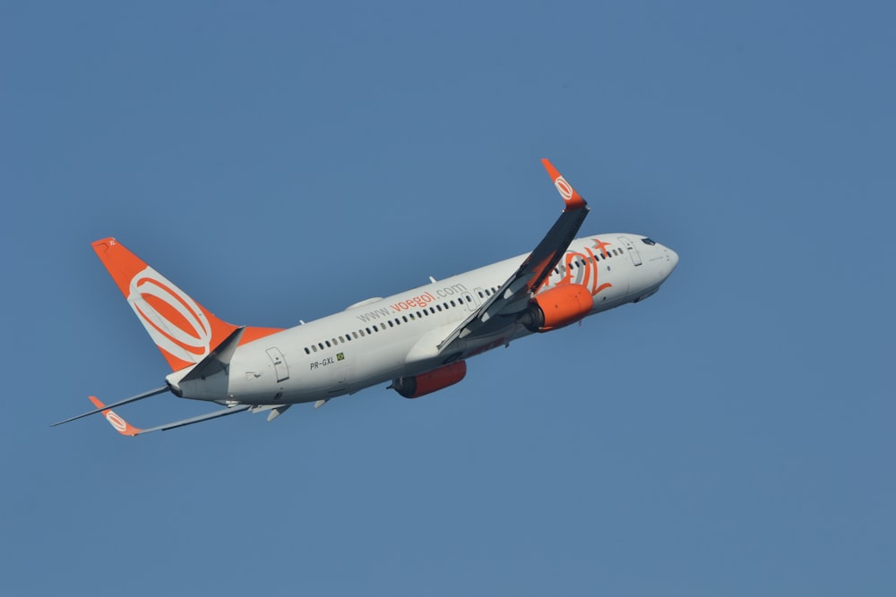 a large jetliner flying through a blue sky