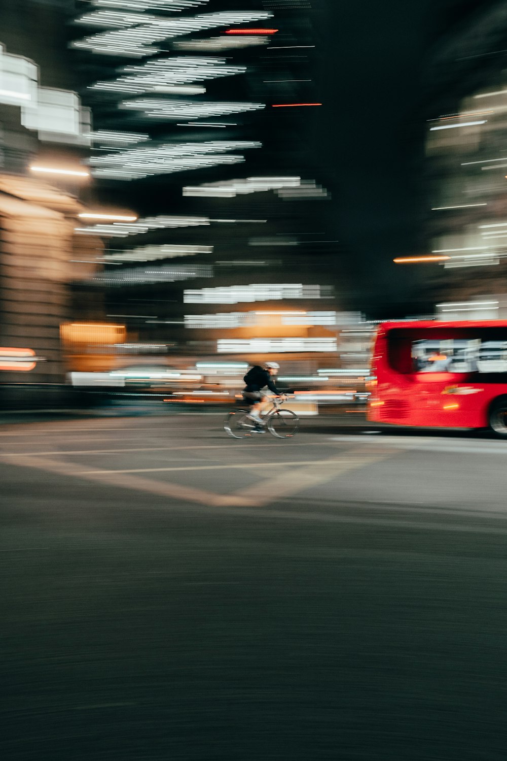a blurry photo of a red bus on a city street