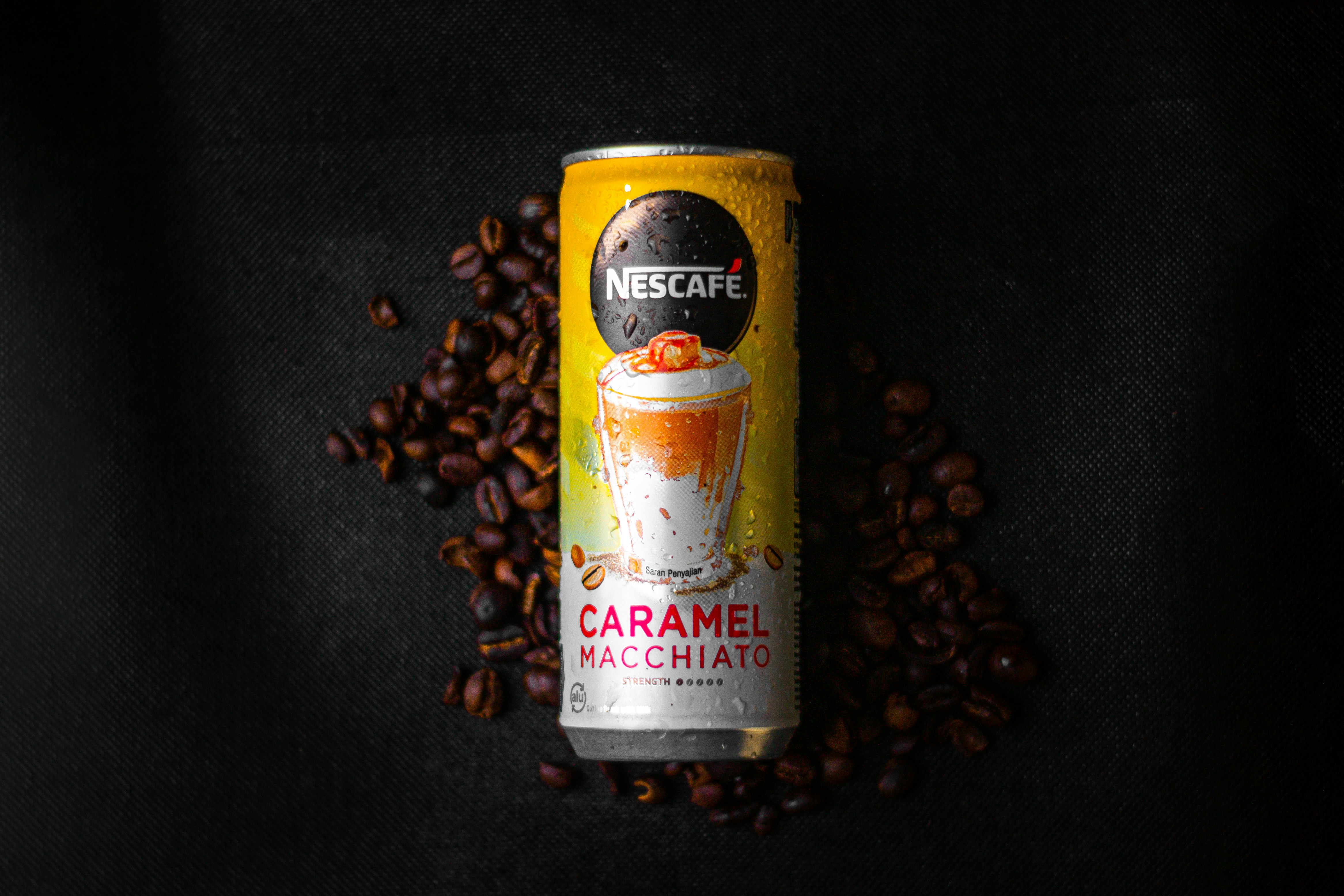 a can of coffee sitting on top of a pile of coffee beans