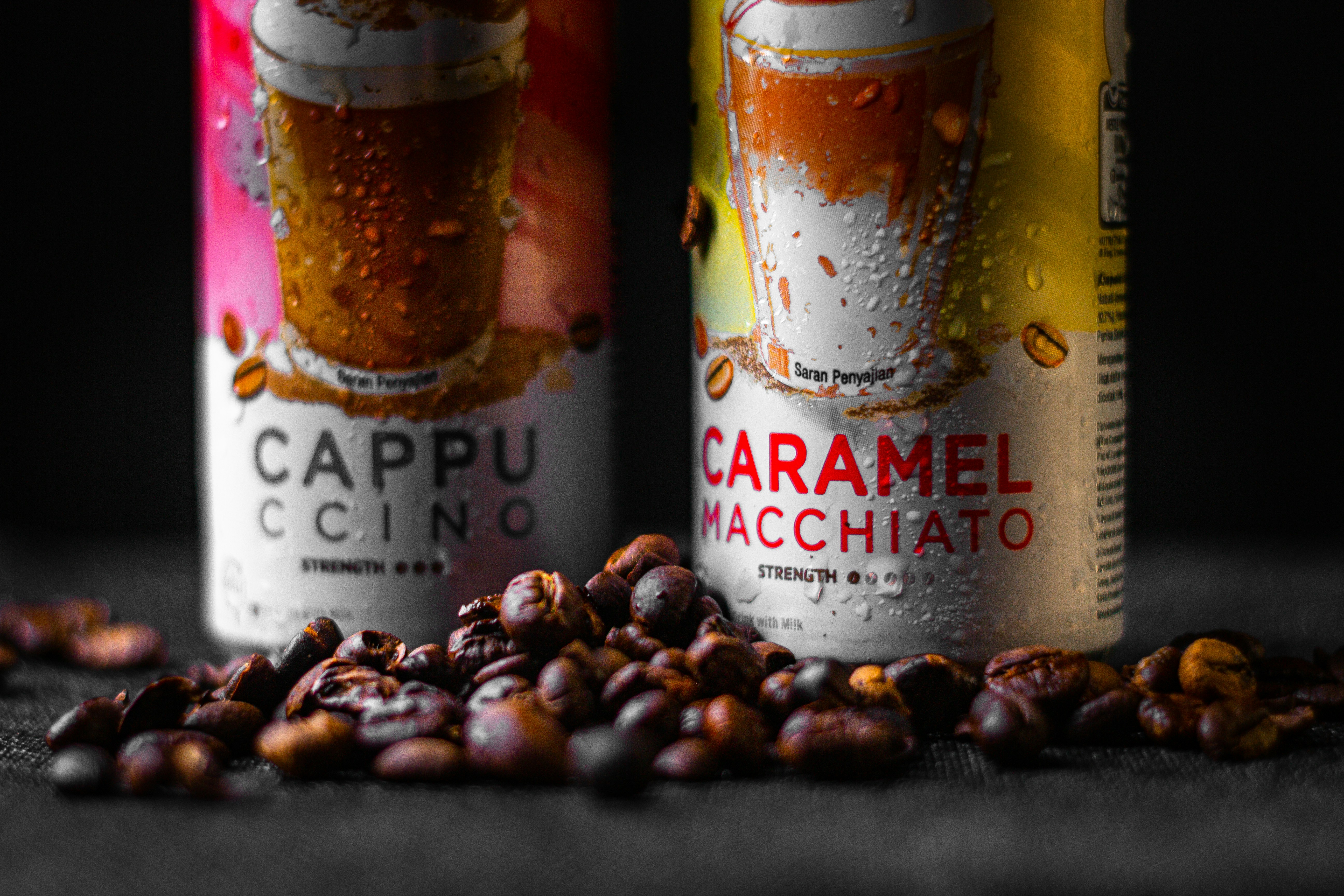 two cans of caramel macchiato on a table