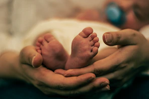 a close up of a person holding a baby