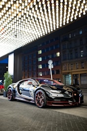Elevé Group a bugatti car parked in front of a building