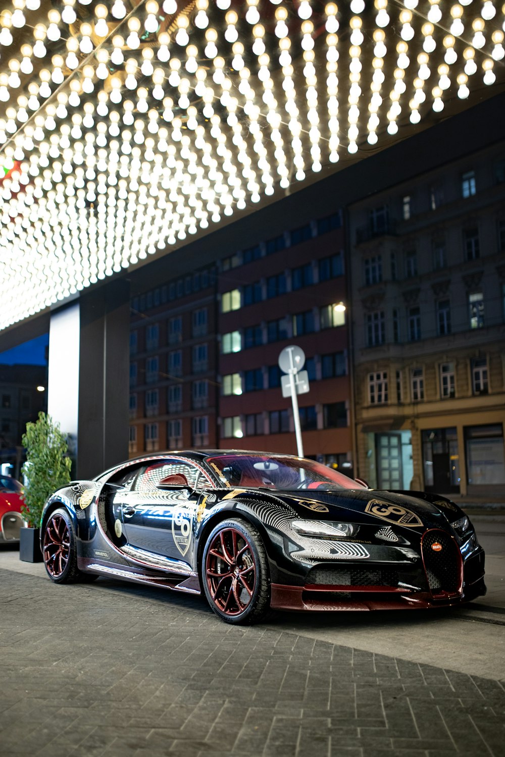 a bugatti car parked in front of a building