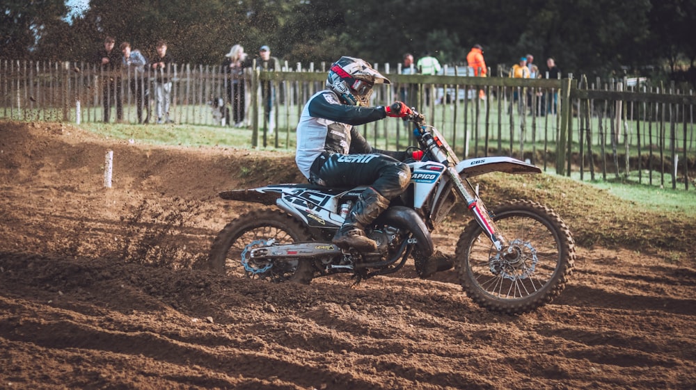 a person riding a dirt bike on a dirt track