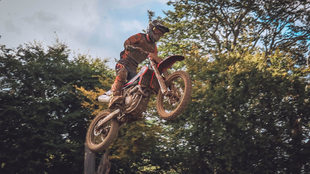 a person on a dirt bike doing a trick in the air