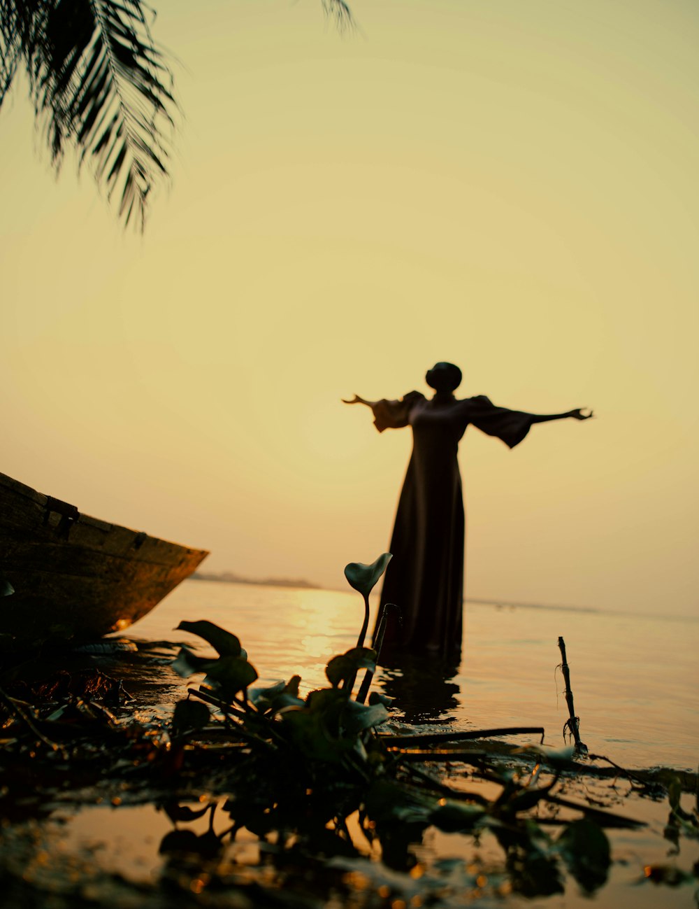 a woman standing in the water with her arms outstretched