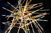 a pile of toothpicks on a black surface