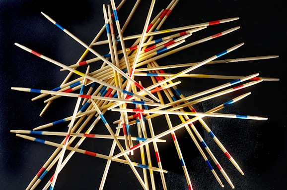 a pile of toothpicks on a black surface