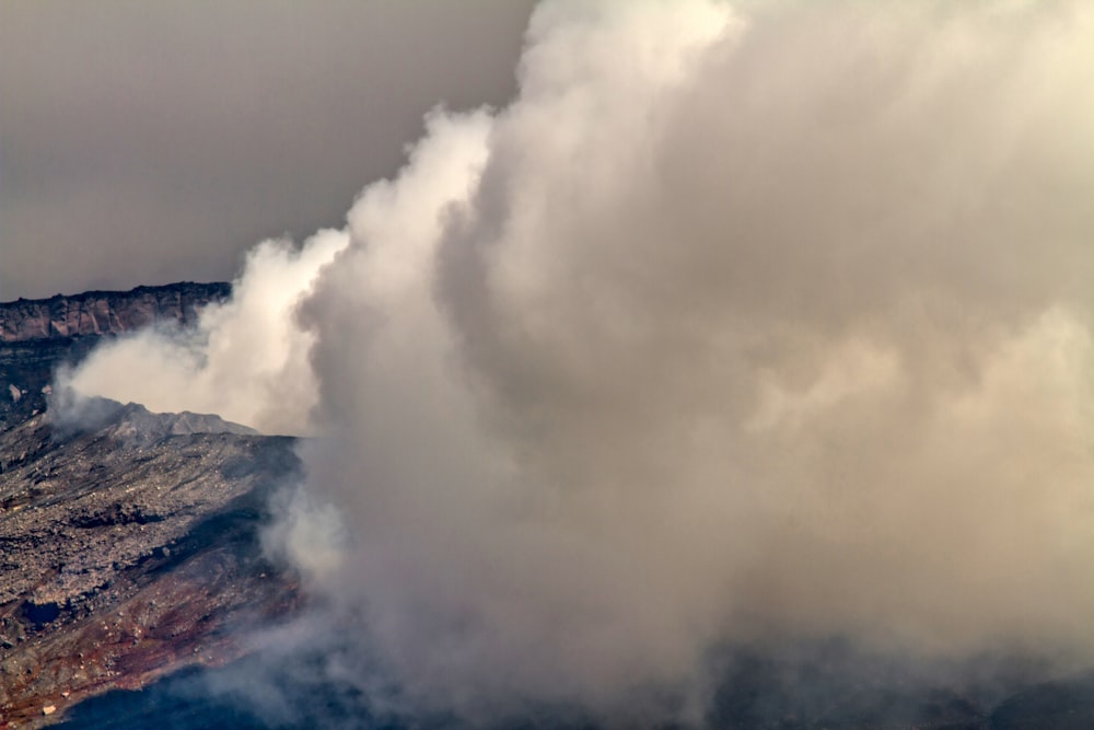 a large plume of smoke coming out of a mountain