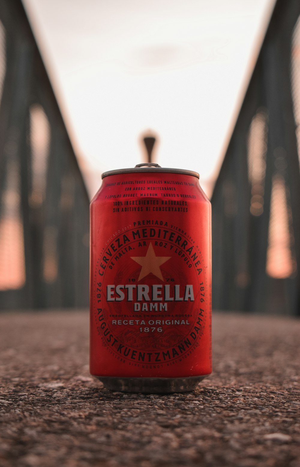 a can of beer sitting on the ground