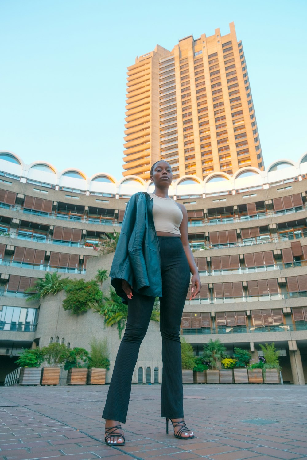 a woman standing in front of a large building