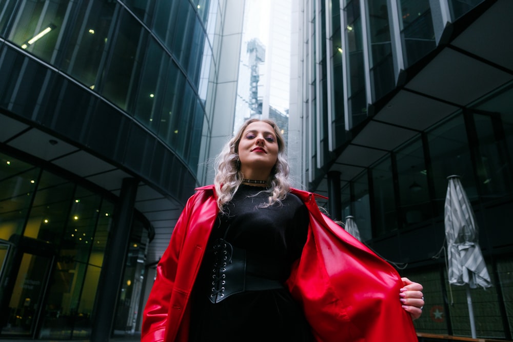 a woman in a black dress and a red jacket