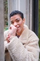 Portrait photo of the website owner smiling warmly in a casual setting