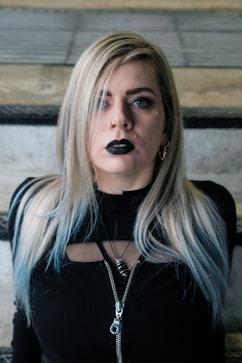 a woman with black lipstick on her face