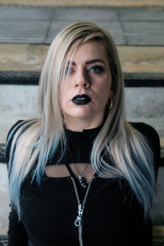 a woman with black lipstick on her face