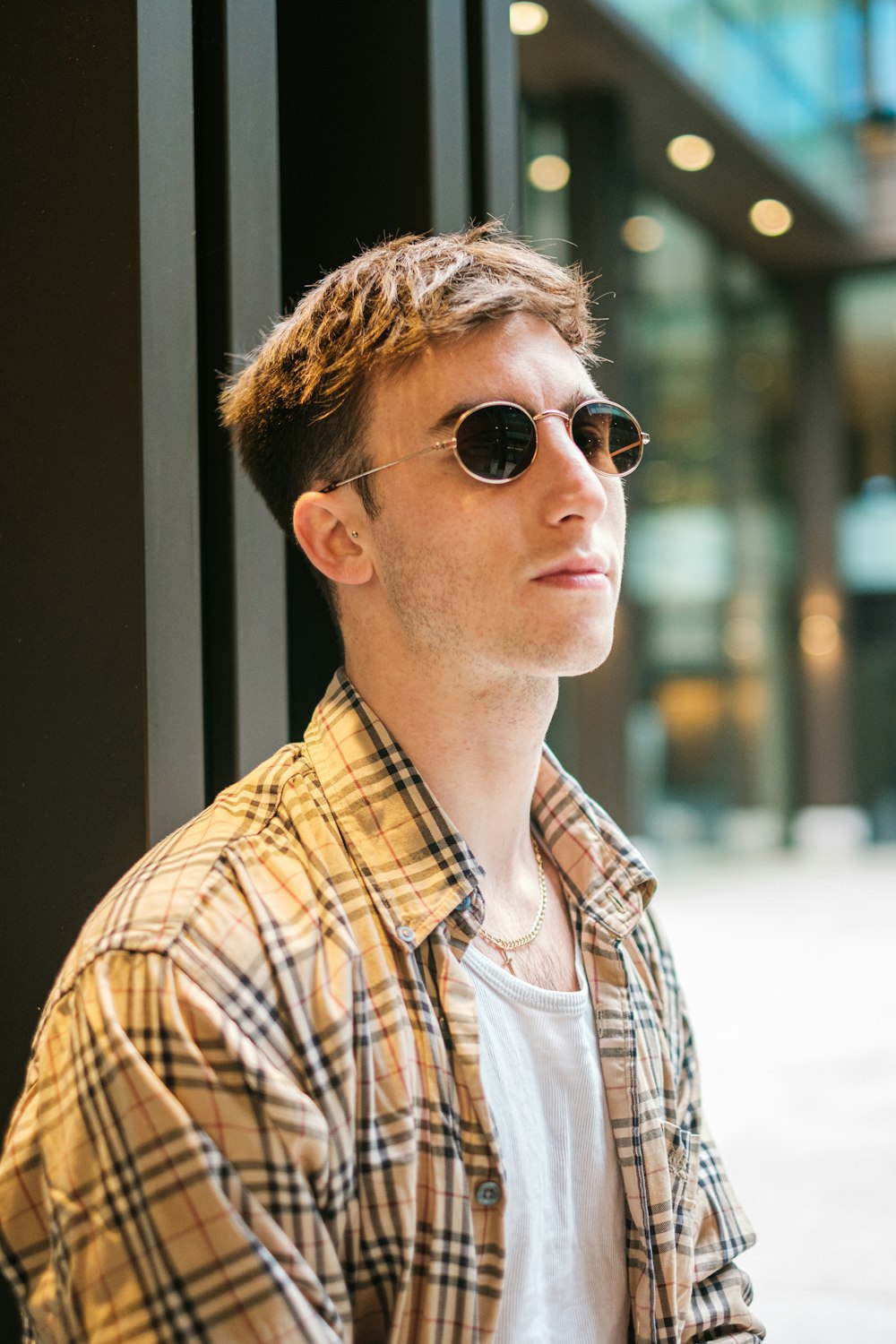 a man in a plaid shirt and sunglasses