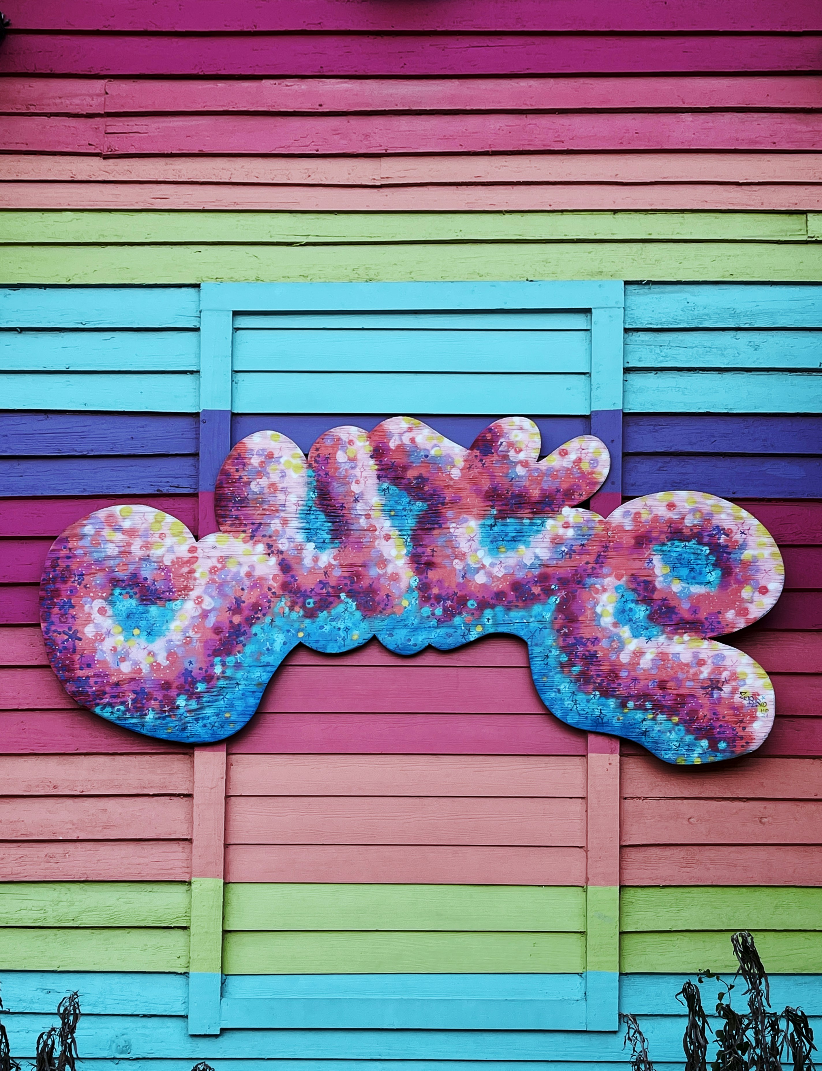 a colorful building with a large donut painted on the side