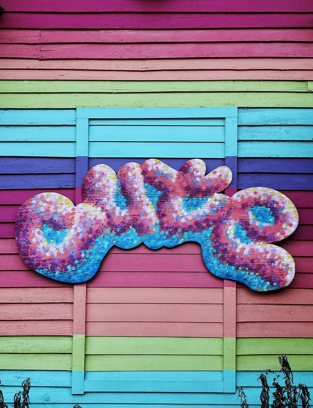 a colorful building with a large donut painted on the side