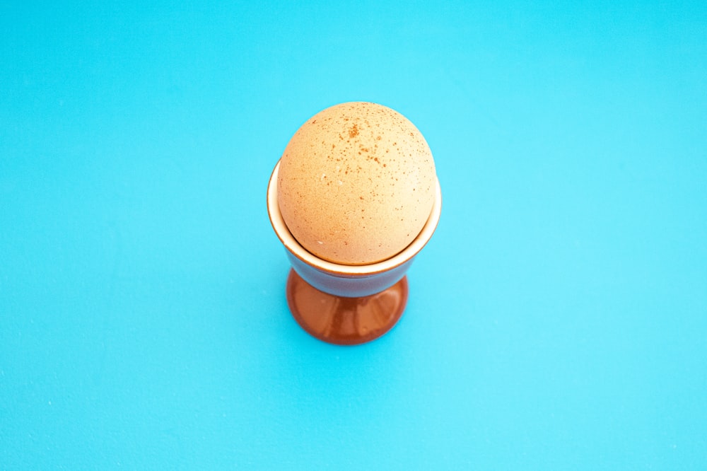 an egg sitting on top of a wooden stand