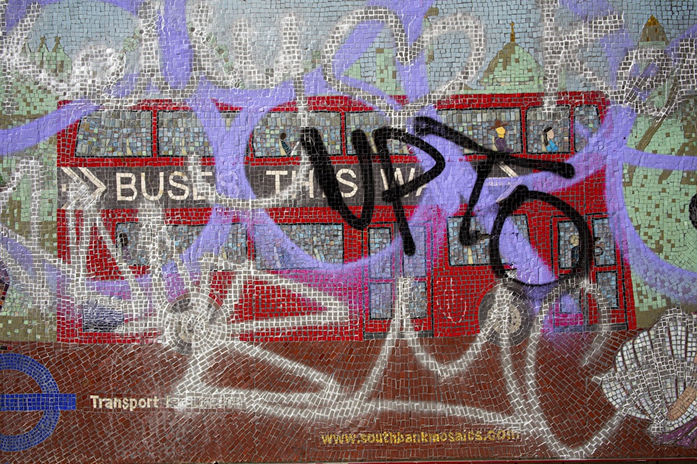a painting of a bus with graffiti on it