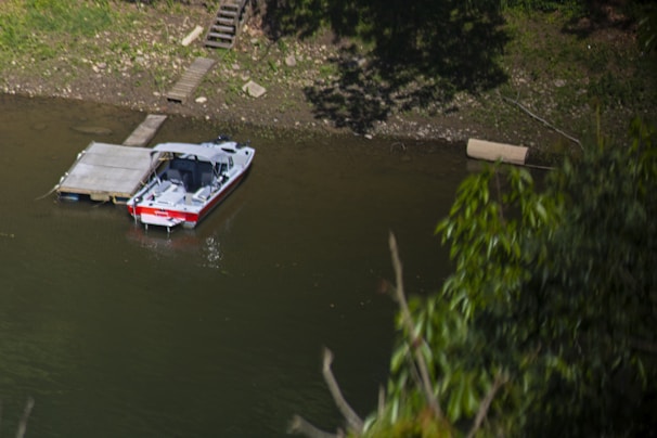 Riverside dock with a small boat, perfect for fishing and relaxation.