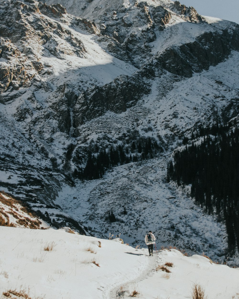 a person walking up a snow covered mountain