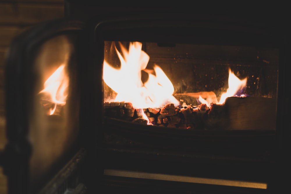a fire burning inside of a wood burning stove