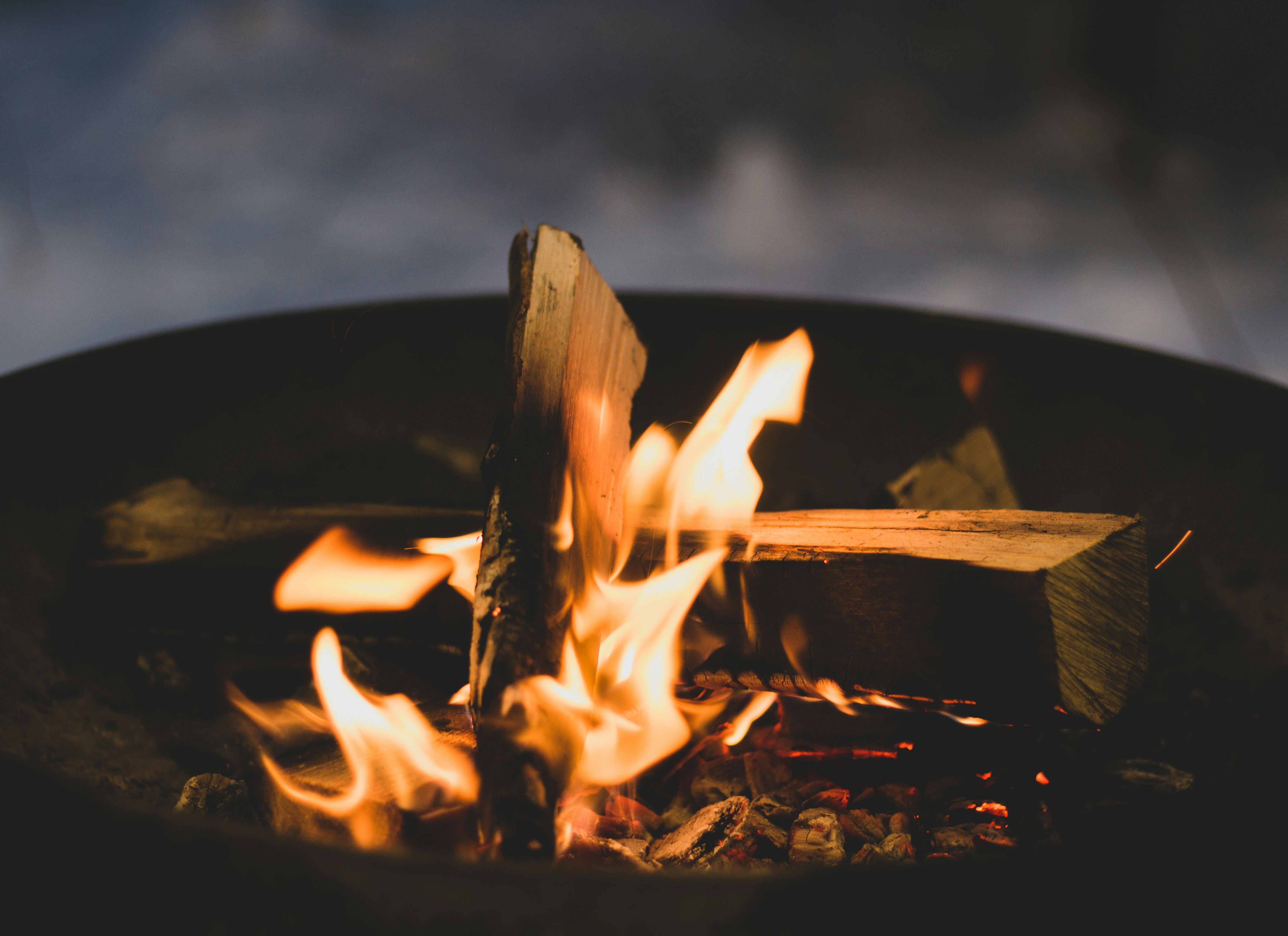 a close up of a fire in a metal bowl
