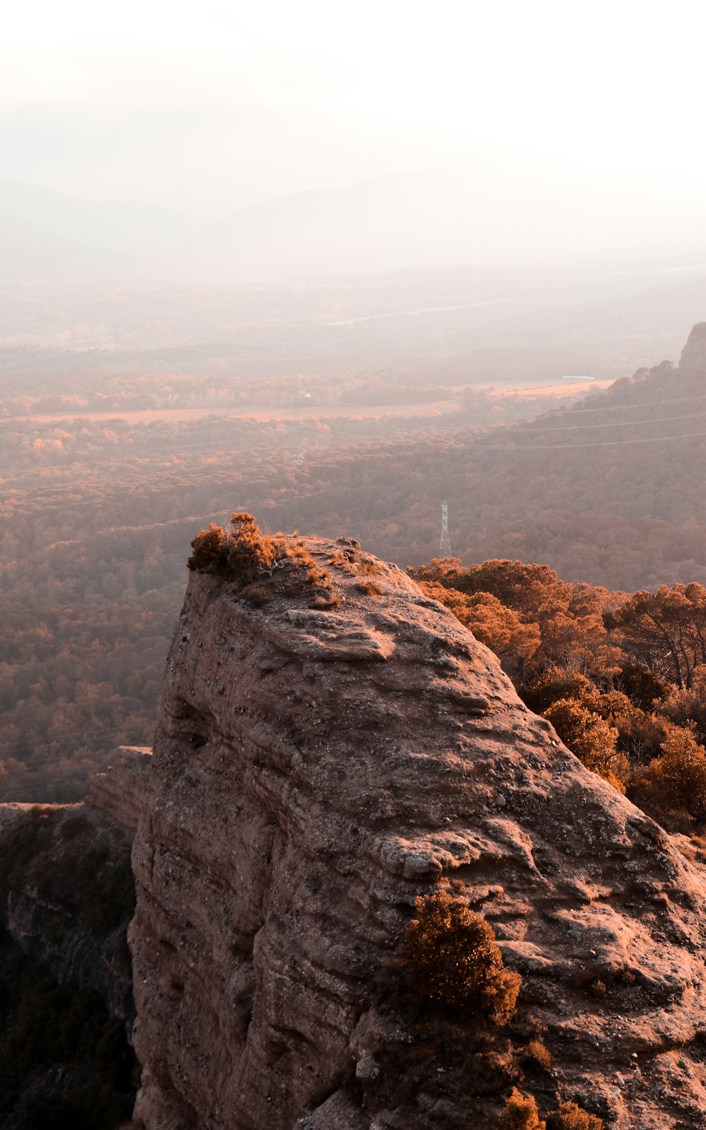 a person standing on top of a large rock