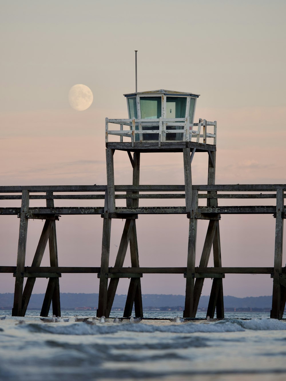 a pier with a light house on top of it