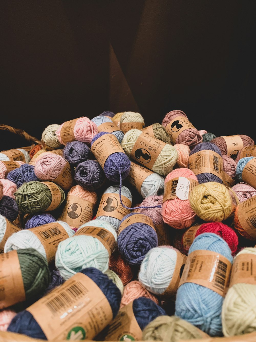 a basket filled with balls of yarn sitting on top of a table