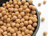 a bowl filled with chickpeas sitting on top of a table