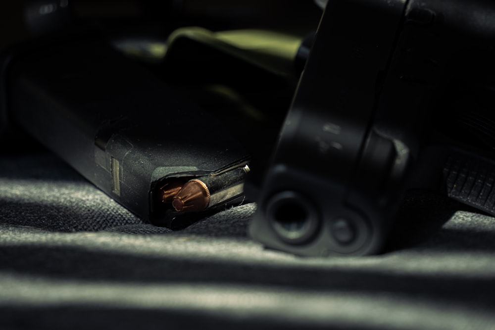 a close up of a gun on a bed