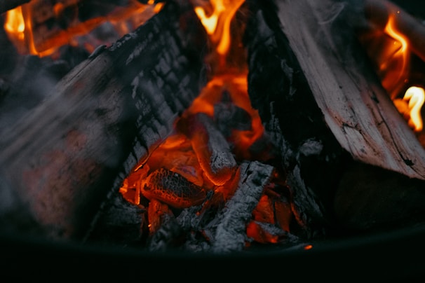 Close-up of glowing embers inside a pellet stove creating a warm ambiance
