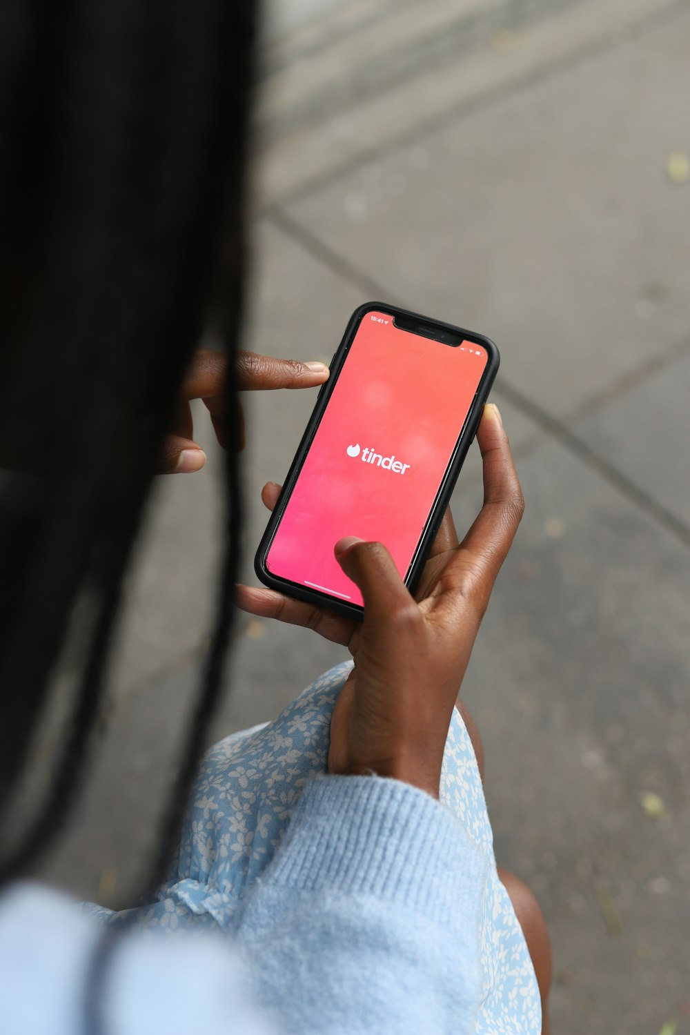 a person holding a cell phone in their hand