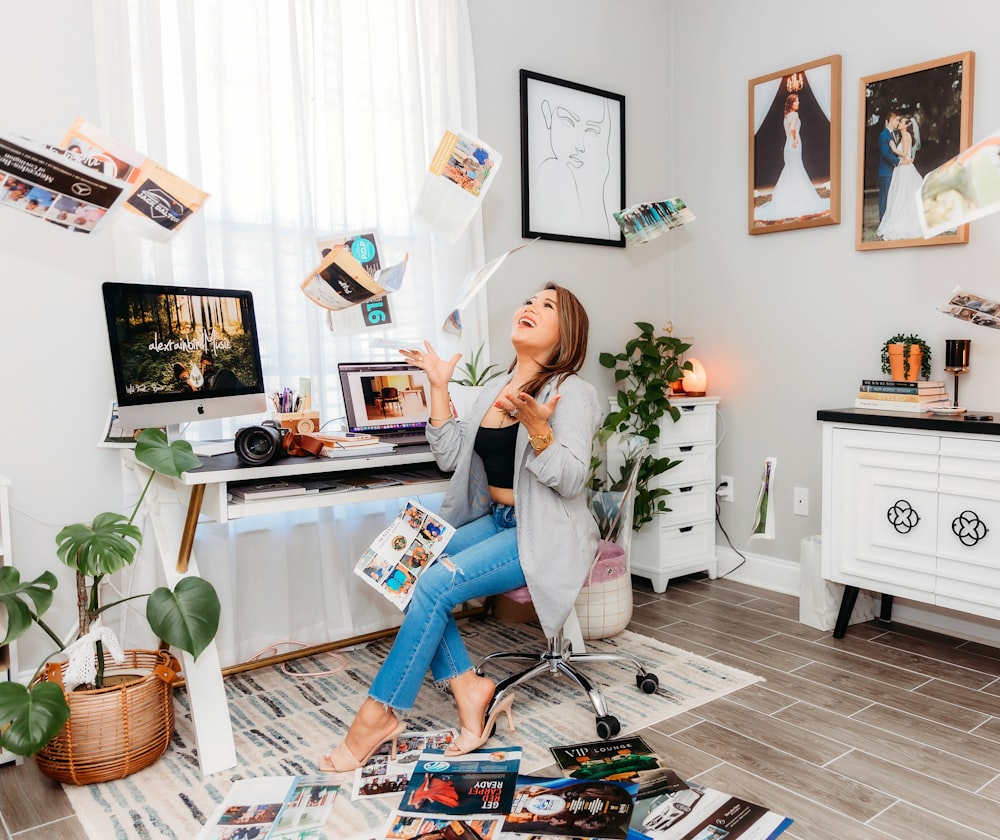 a woman sitting on a chair in front of a computer